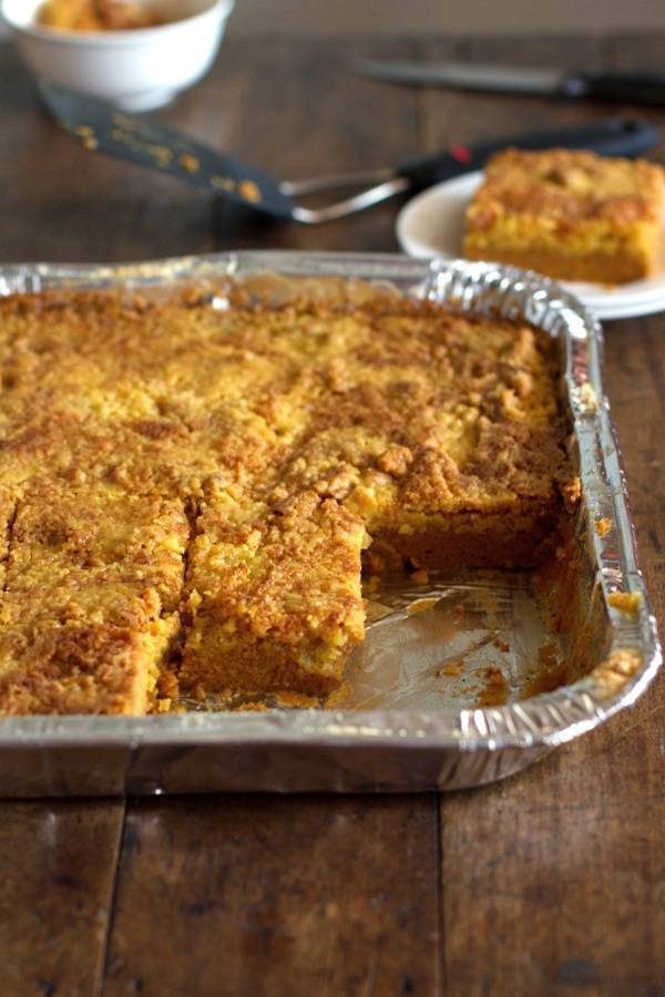 Pumpkin dessert bars in a tin dish.