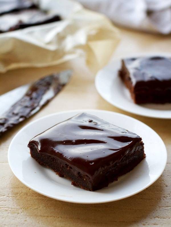 Fudgy chocolate cake bars on plates.