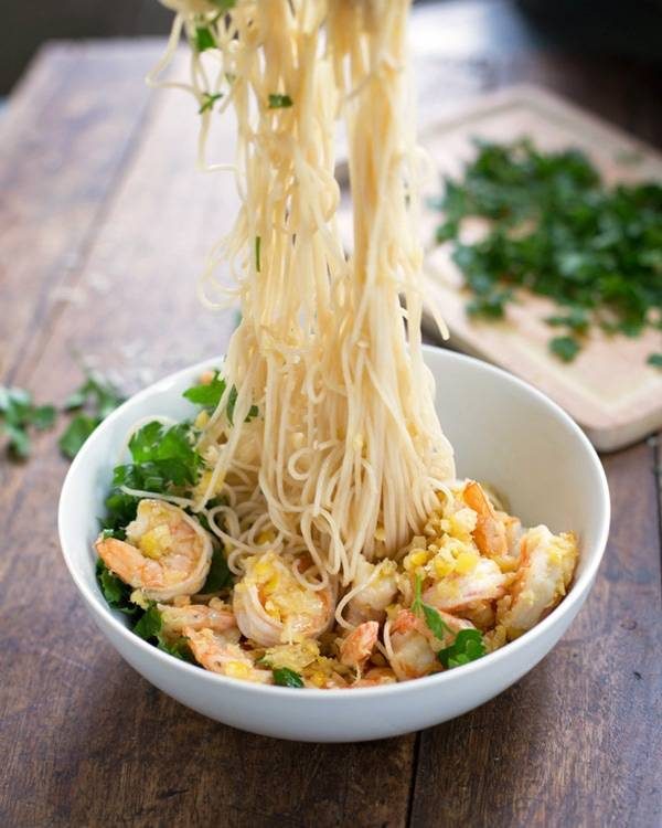 Shrimp scampi in a bowl with noodles.