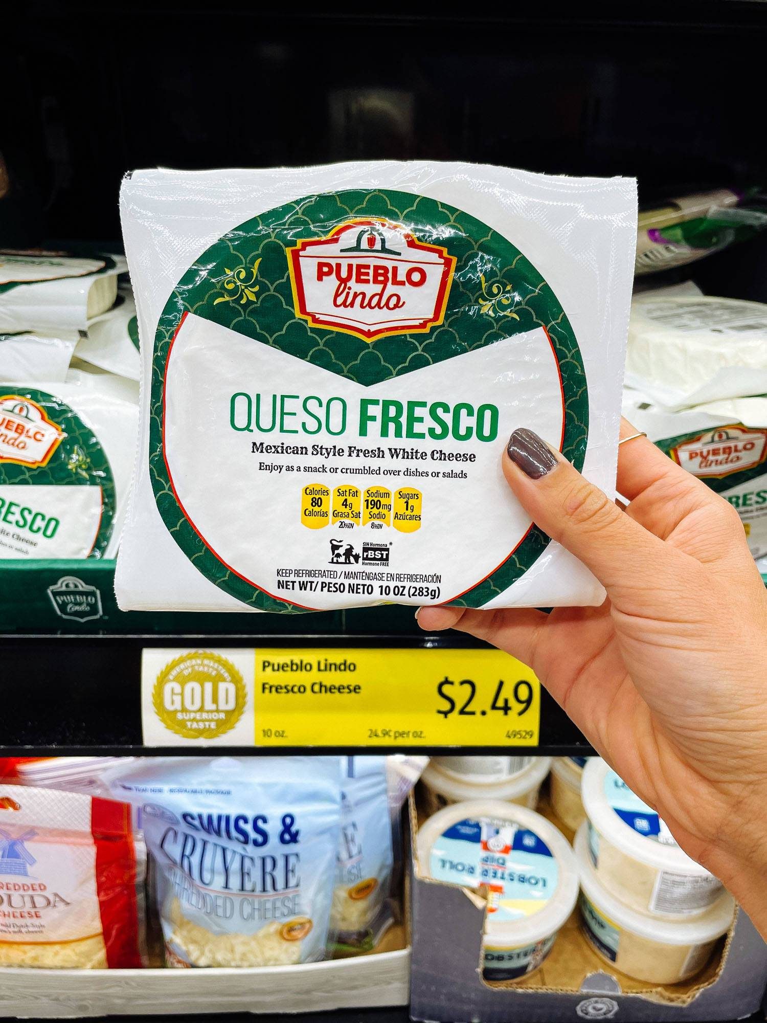 White hand holding queso fresco from ALDI.