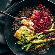 Baked salmon with lentils, green beans, and sauerkraut in bowl.