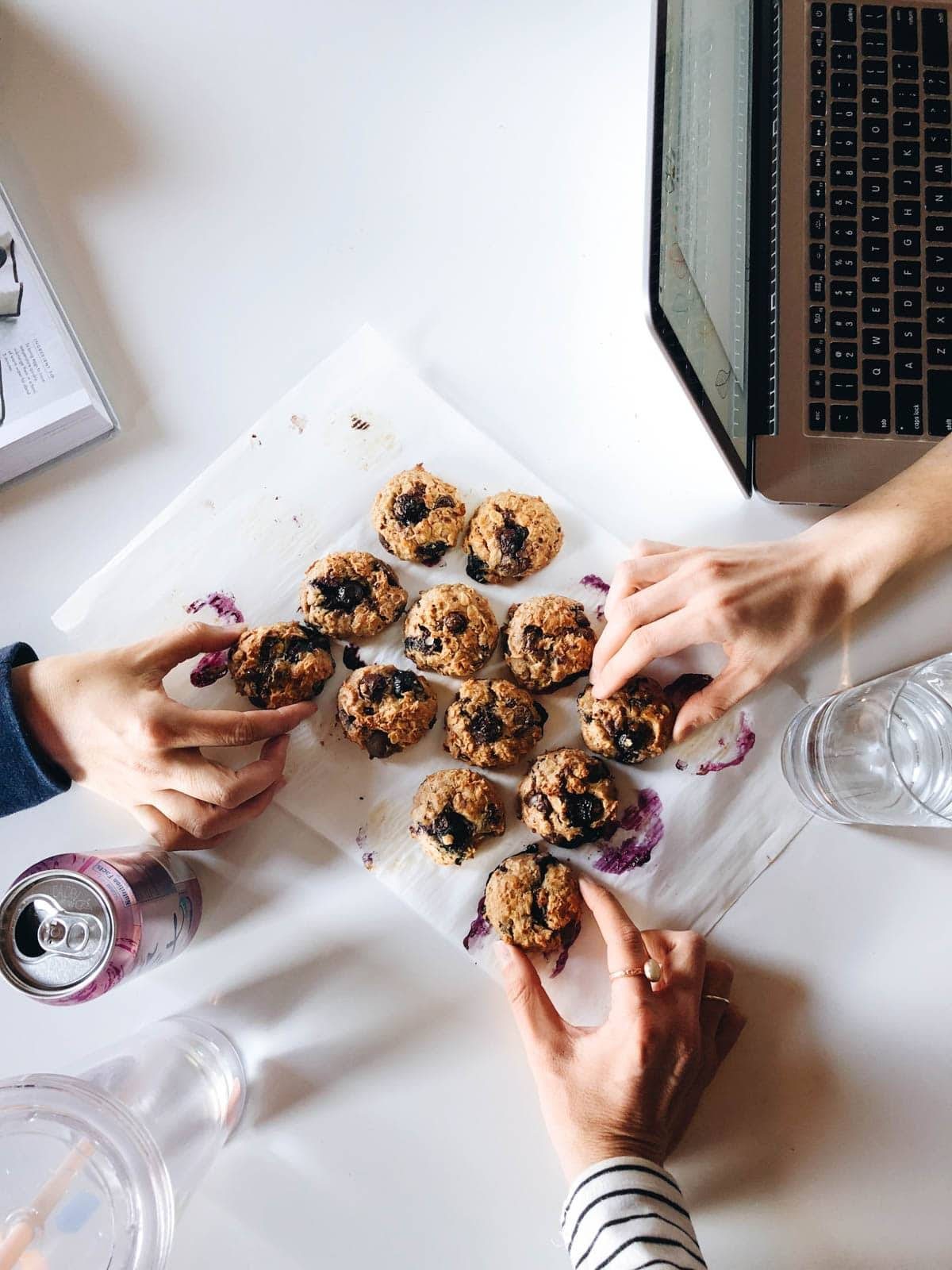 Breakfast Cookies on table with hands grabbing.