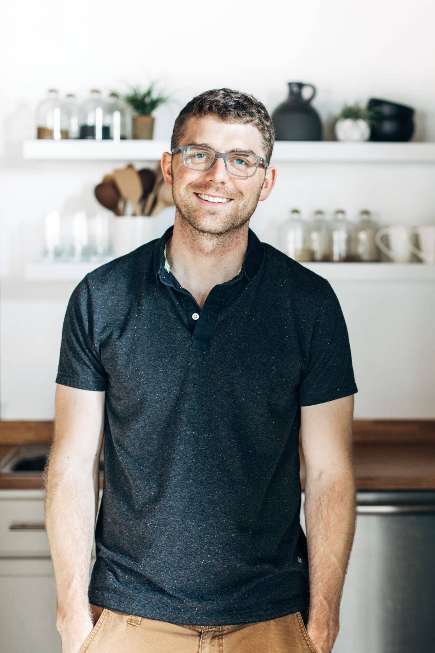 Man smiling in a kitchen.