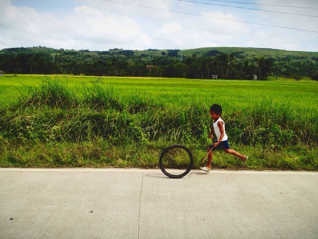 Young boy playing near a field.