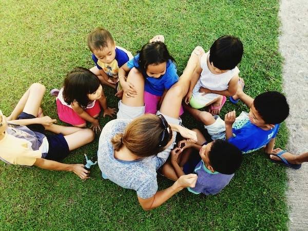 Children around a woman.