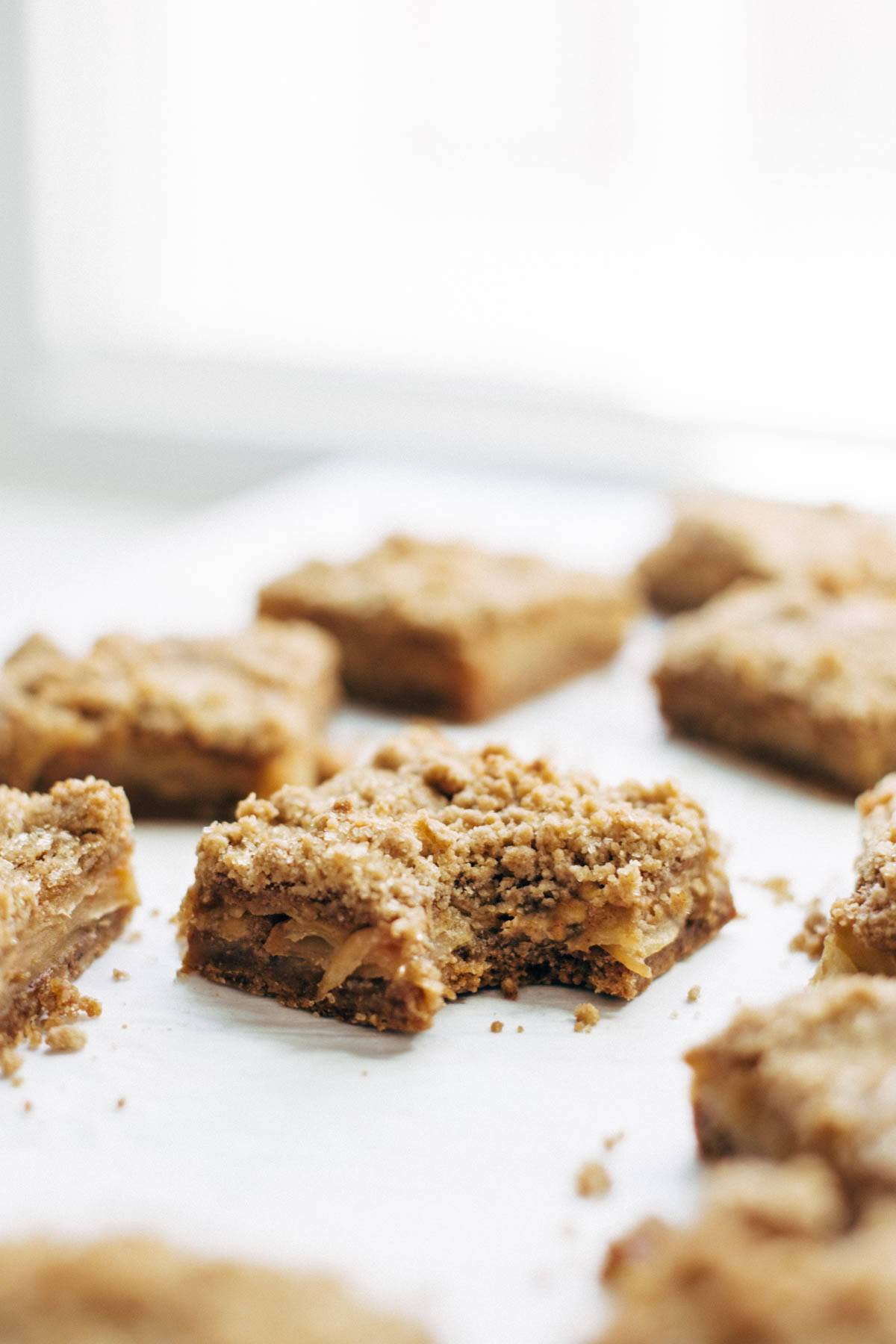 These layered bars are so simple! Loaded with homemade caramel and apples. Caramely apple layer tucked in by a brown sugar-y crust on both sides. | pinchofyum.com These layered bars are so simple! Loaded with homemade caramel and apples. Caramely apple layer tucked in by a brown sugar-y crust on both sides. | pinchofyum.com