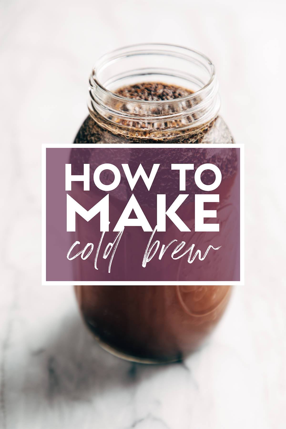 Image of a mason jar filled with coffee grounds and water steeping to make cold brew. There's text over the jar that says "How to Make Cold Brew"