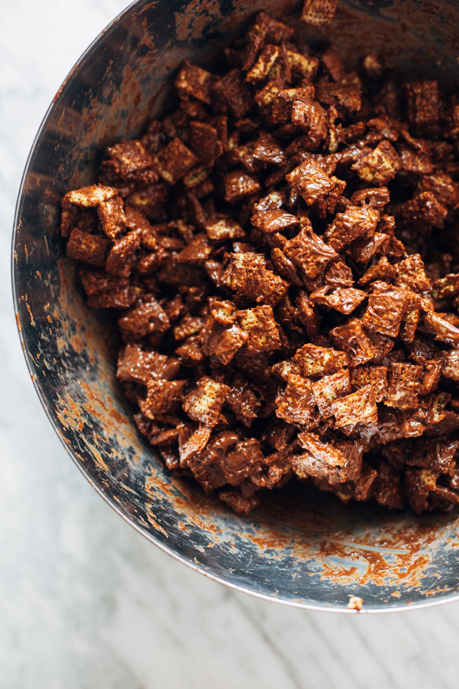 Melted chocolate and chex mix together in a bowl.