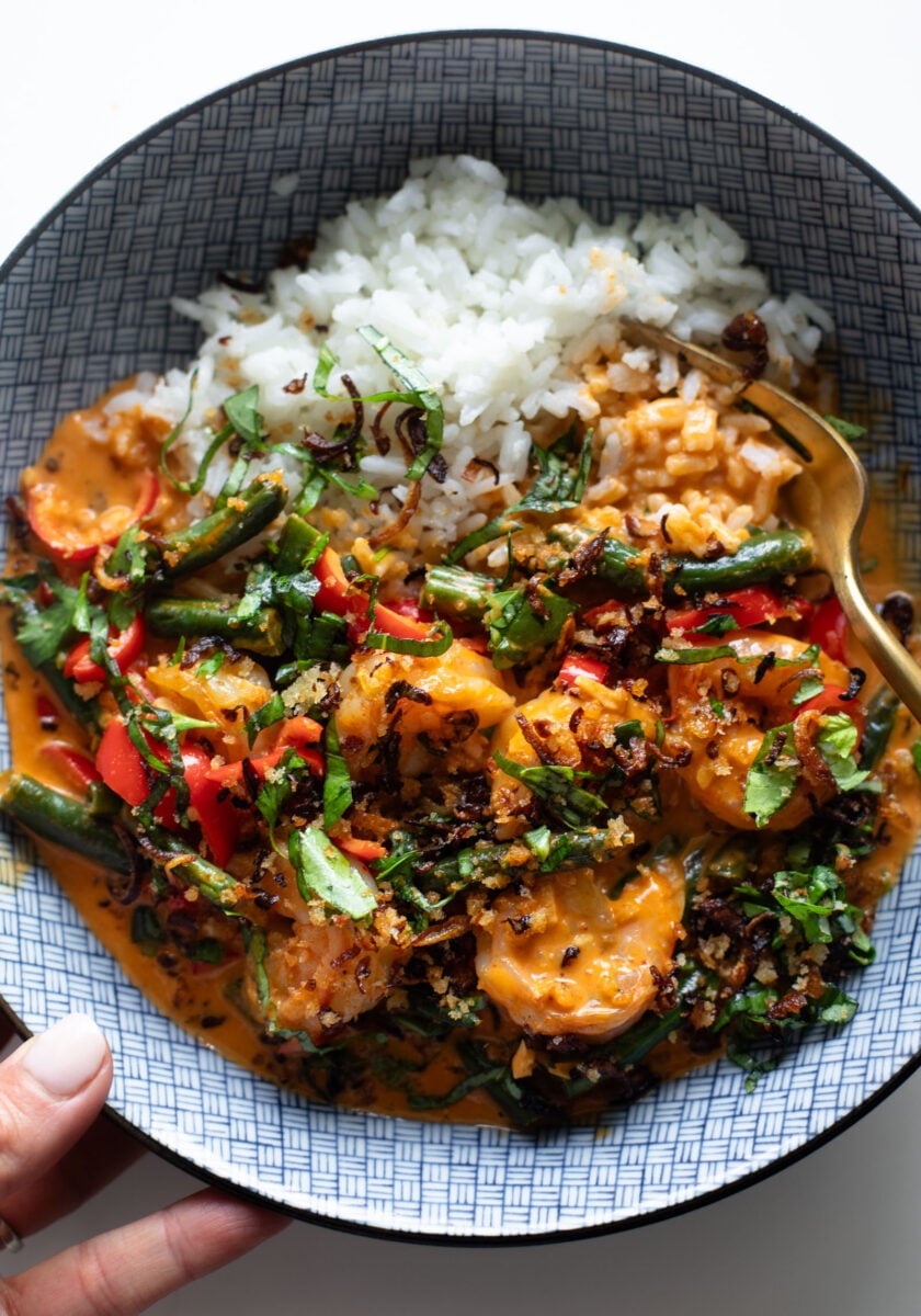 Shrimp curry in a bowl with rice.