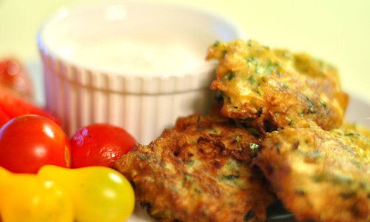 Zucchini Fritters with goat cheese sauce and tomatoes.