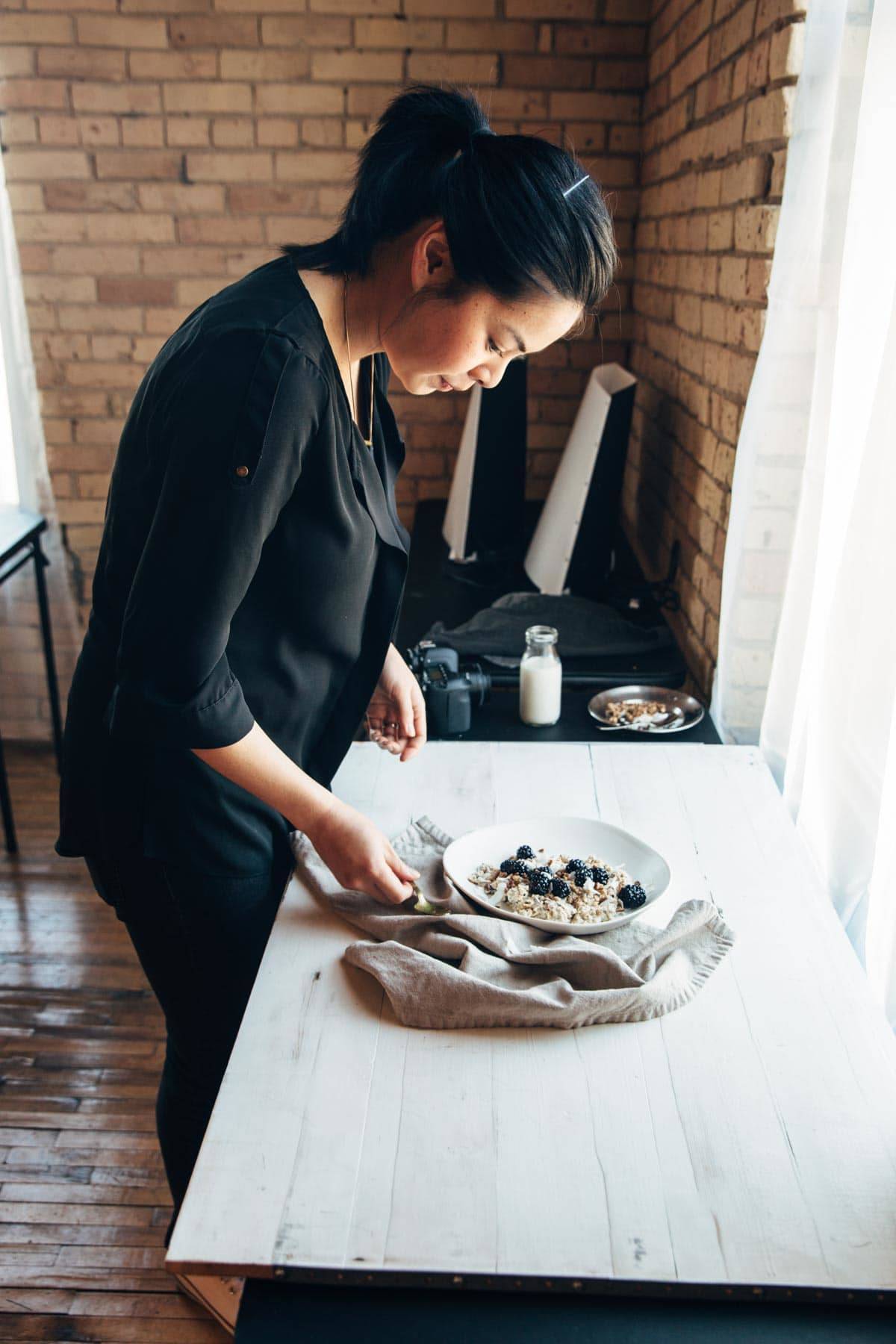 Woman styling food with a napkin.